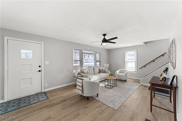 living room featuring ceiling fan and light hardwood / wood-style floors