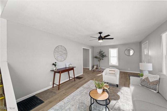 living room with light hardwood / wood-style floors and ceiling fan