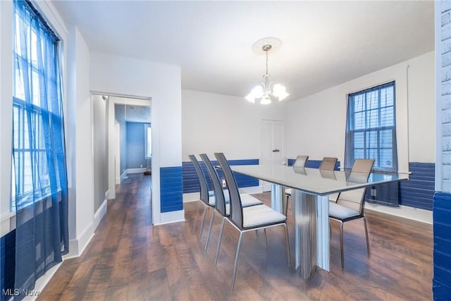 dining room featuring an inviting chandelier, dark hardwood / wood-style floors, and a wealth of natural light