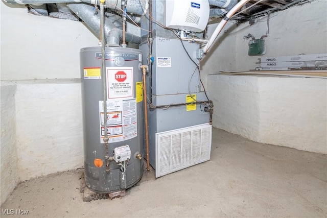 utility room with heating unit and gas water heater