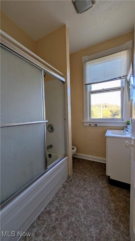 full bathroom with toilet, vanity, and enclosed tub / shower combo