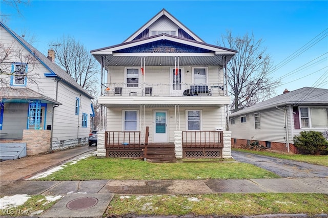 view of front facade featuring a balcony and covered porch