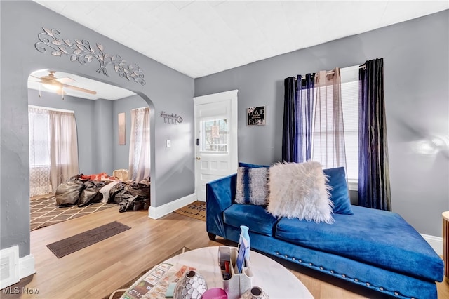 living room featuring hardwood / wood-style floors and ceiling fan