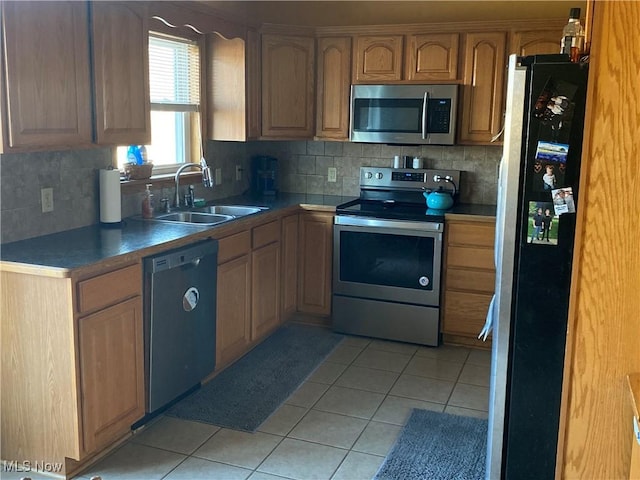 kitchen with stainless steel appliances, sink, light tile patterned floors, and backsplash