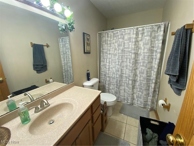 bathroom with vanity, toilet, curtained shower, and tile patterned flooring