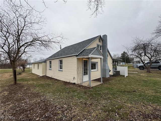 view of home's exterior featuring a yard and central AC unit