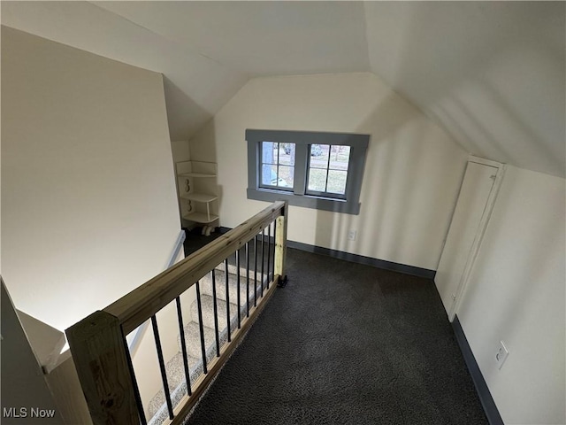 bonus room featuring vaulted ceiling and carpet floors