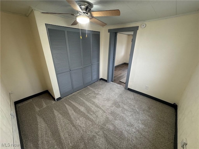 unfurnished bedroom with ceiling fan, a closet, and carpet