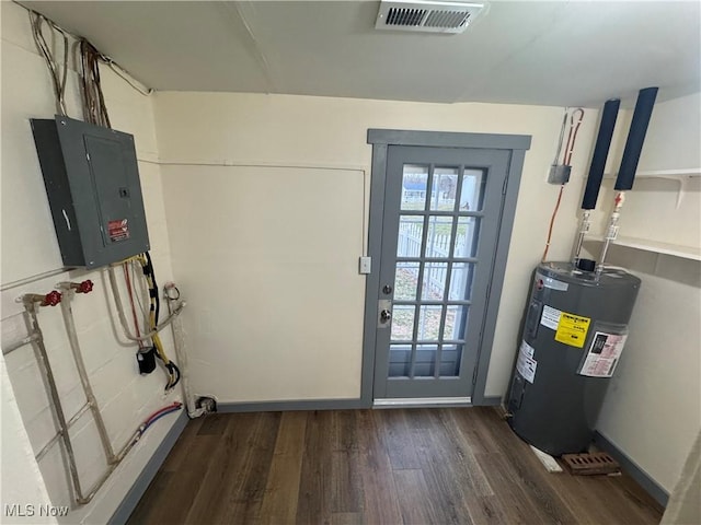 doorway with electric water heater, dark wood-type flooring, and electric panel