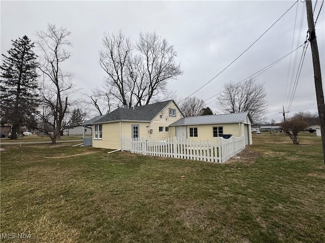 rear view of property featuring a yard