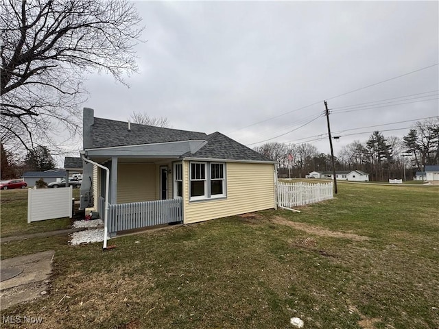 back of house with a yard and covered porch