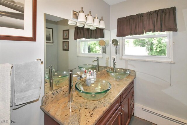 bathroom featuring vanity and baseboard heating