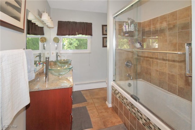 bathroom featuring vanity, tile patterned floors, shower / bath combination with glass door, and baseboard heating