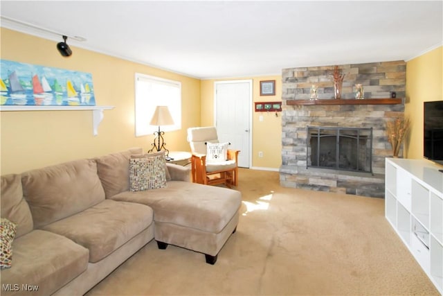 carpeted living room featuring ornamental molding and a fireplace