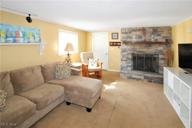 living room featuring crown molding, a stone fireplace, and carpet flooring