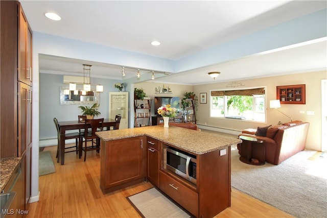 kitchen featuring baseboard heating, ornamental molding, decorative light fixtures, and light stone counters