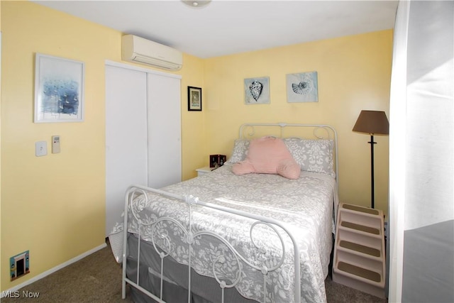 carpeted bedroom featuring an AC wall unit and a closet