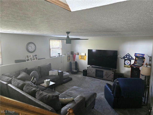 living room with ceiling fan, carpet flooring, and a textured ceiling