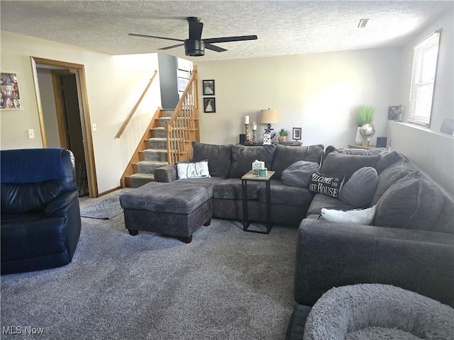 carpeted living room featuring a textured ceiling and ceiling fan