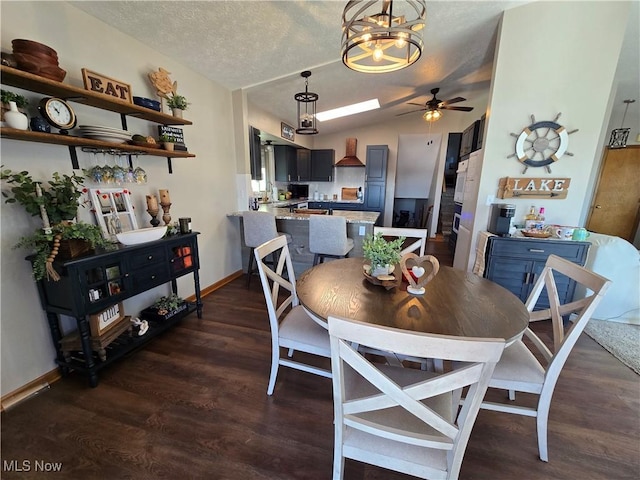 dining space featuring lofted ceiling, a textured ceiling, dark hardwood / wood-style floors, and ceiling fan