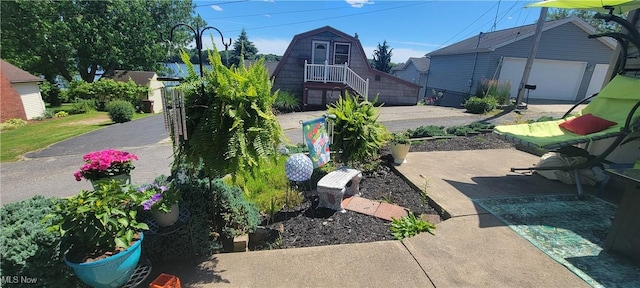 view of patio / terrace with an outbuilding and a garage