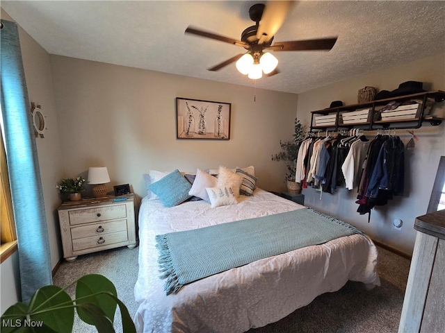 bedroom with ceiling fan and a textured ceiling