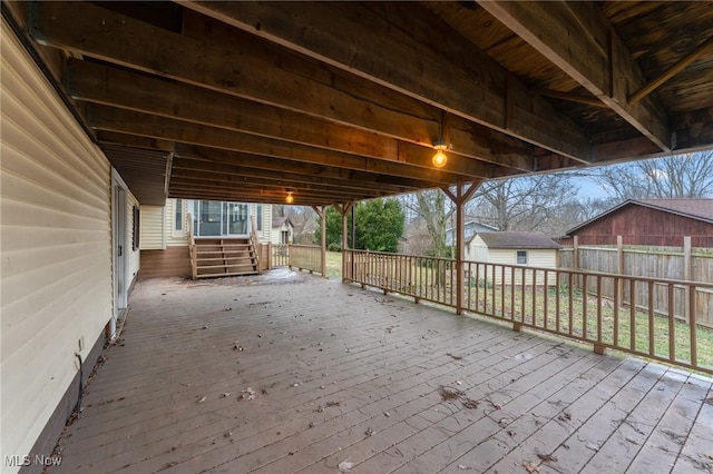 wooden deck featuring a storage unit