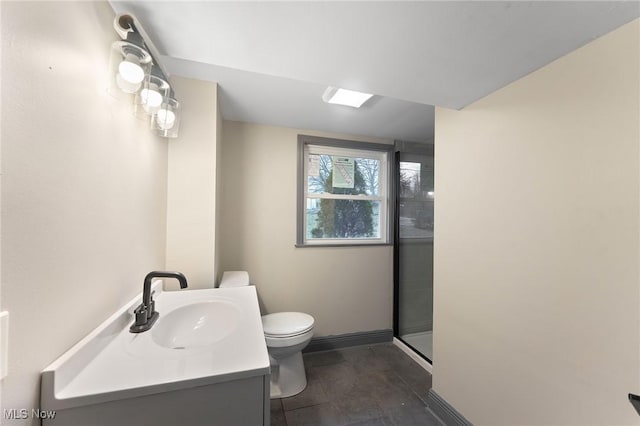 bathroom with vanity, an enclosed shower, and toilet