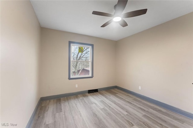 empty room with ceiling fan and light wood-type flooring