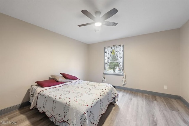 bedroom with hardwood / wood-style floors and ceiling fan