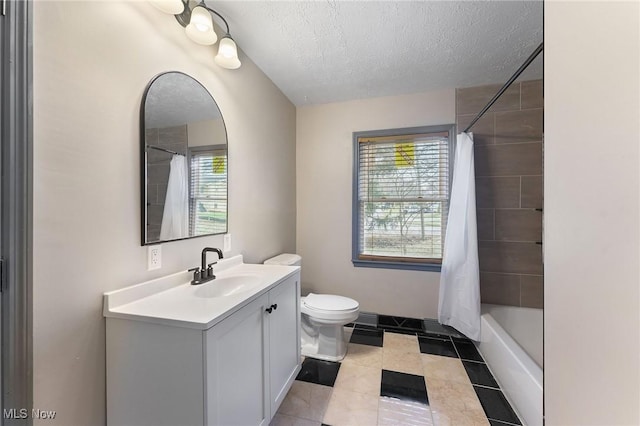 full bathroom featuring vanity, toilet, shower / tub combo, and a textured ceiling