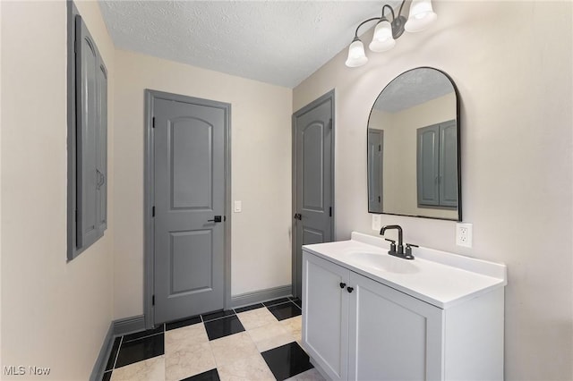 bathroom with vanity and a textured ceiling