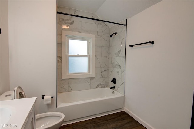 full bathroom featuring tiled shower / bath combo, vanity, wood-type flooring, and toilet