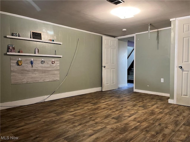 basement with dark hardwood / wood-style floors