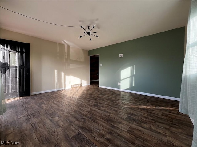 unfurnished room with dark hardwood / wood-style floors