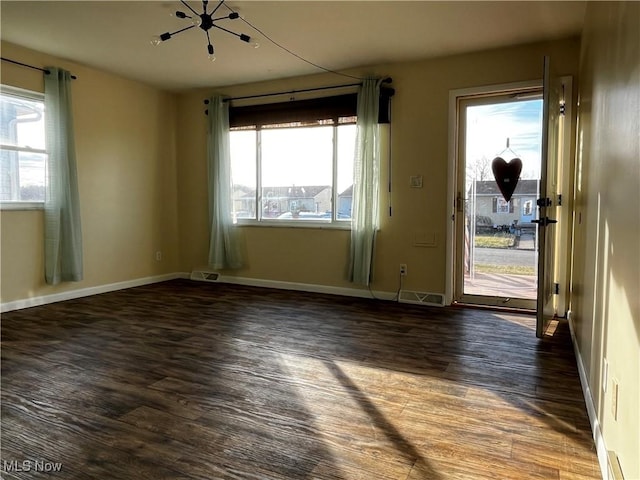 empty room featuring dark wood-type flooring