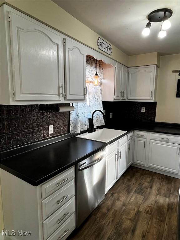 kitchen with dark hardwood / wood-style flooring, dishwasher, sink, and white cabinets