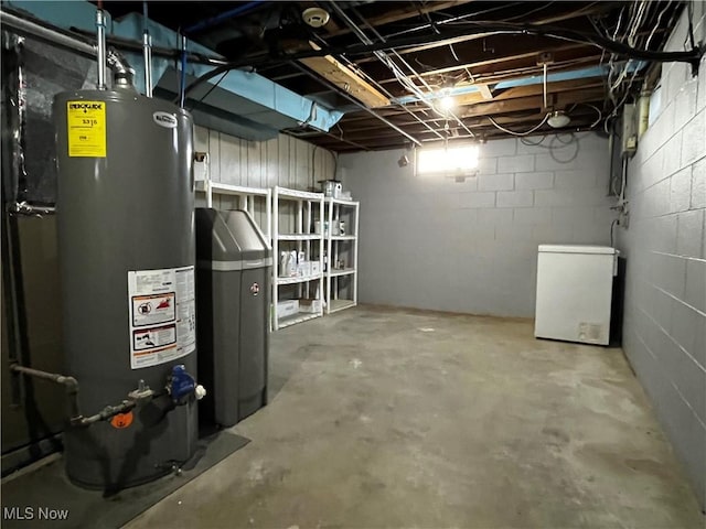 basement featuring fridge and gas water heater