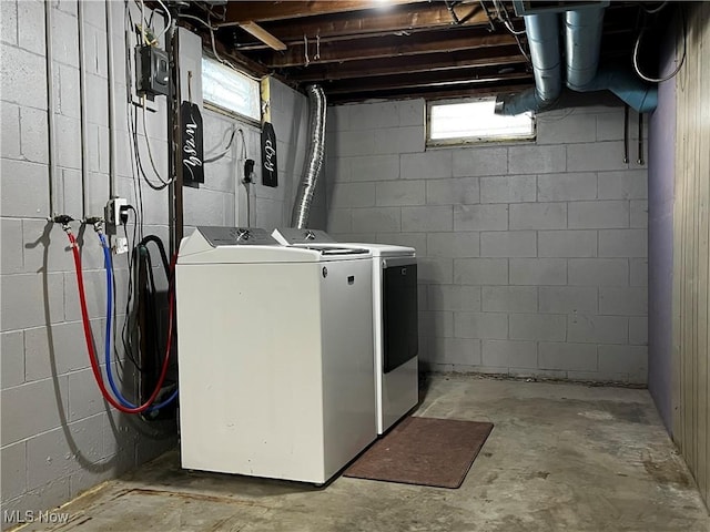 clothes washing area featuring washer and clothes dryer and a healthy amount of sunlight