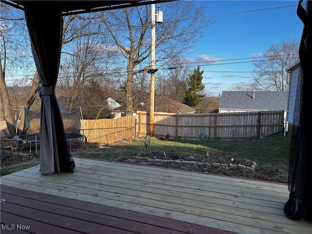 wooden deck featuring a trampoline