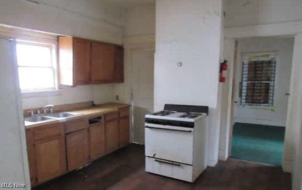 kitchen with electric stove and sink