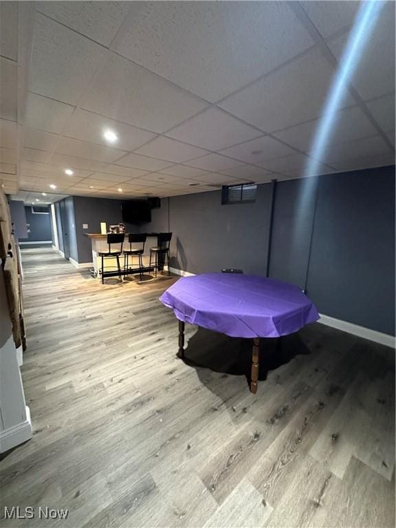 recreation room featuring hardwood / wood-style flooring and a paneled ceiling