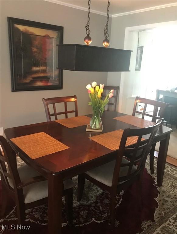 dining area featuring crown molding