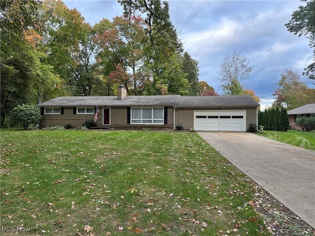 ranch-style house featuring a garage and a front lawn