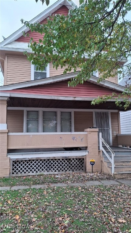 view of side of home with a porch