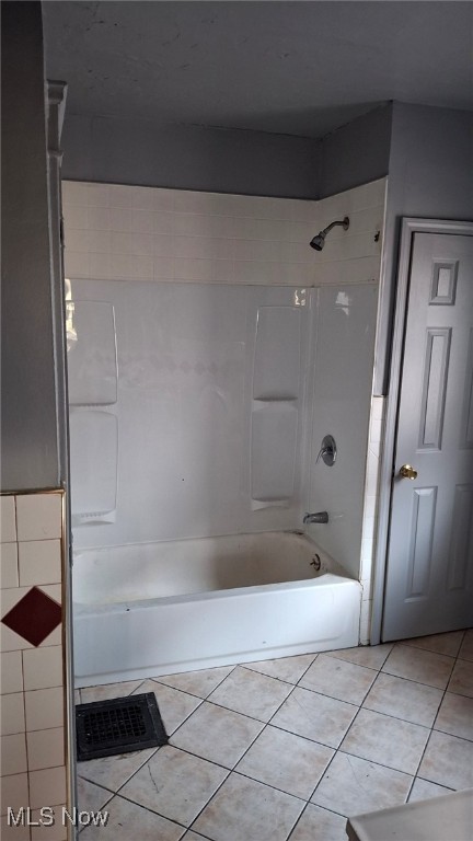 bathroom with tiled shower / bath combo and tile patterned floors