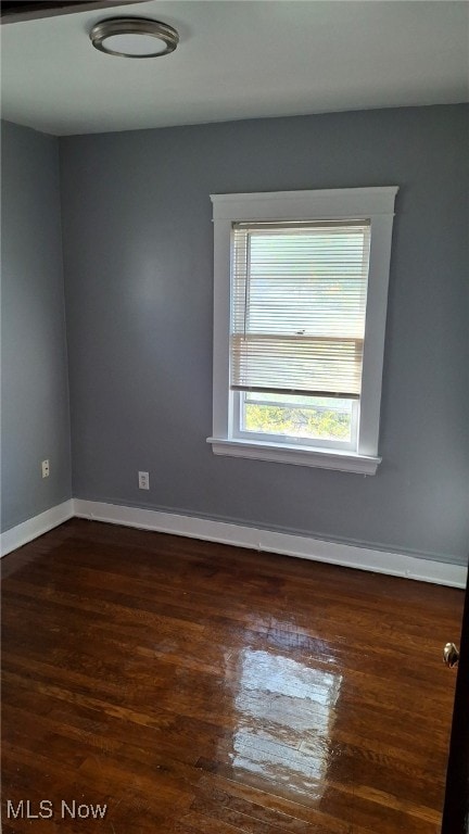 empty room featuring dark wood-type flooring