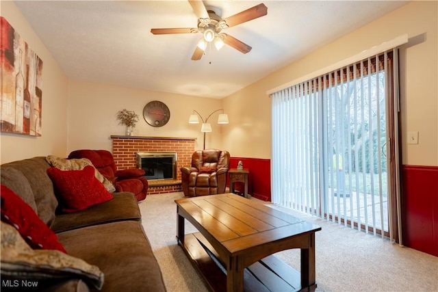 living room featuring a fireplace, carpet, and a wealth of natural light