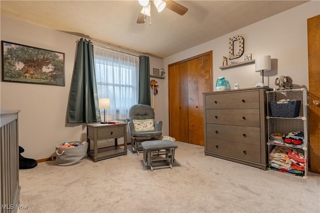 sitting room featuring ceiling fan and carpet floors