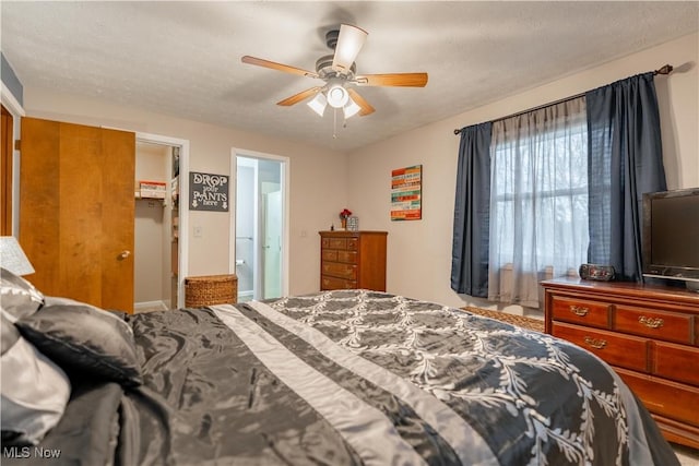 bedroom featuring a textured ceiling and ceiling fan